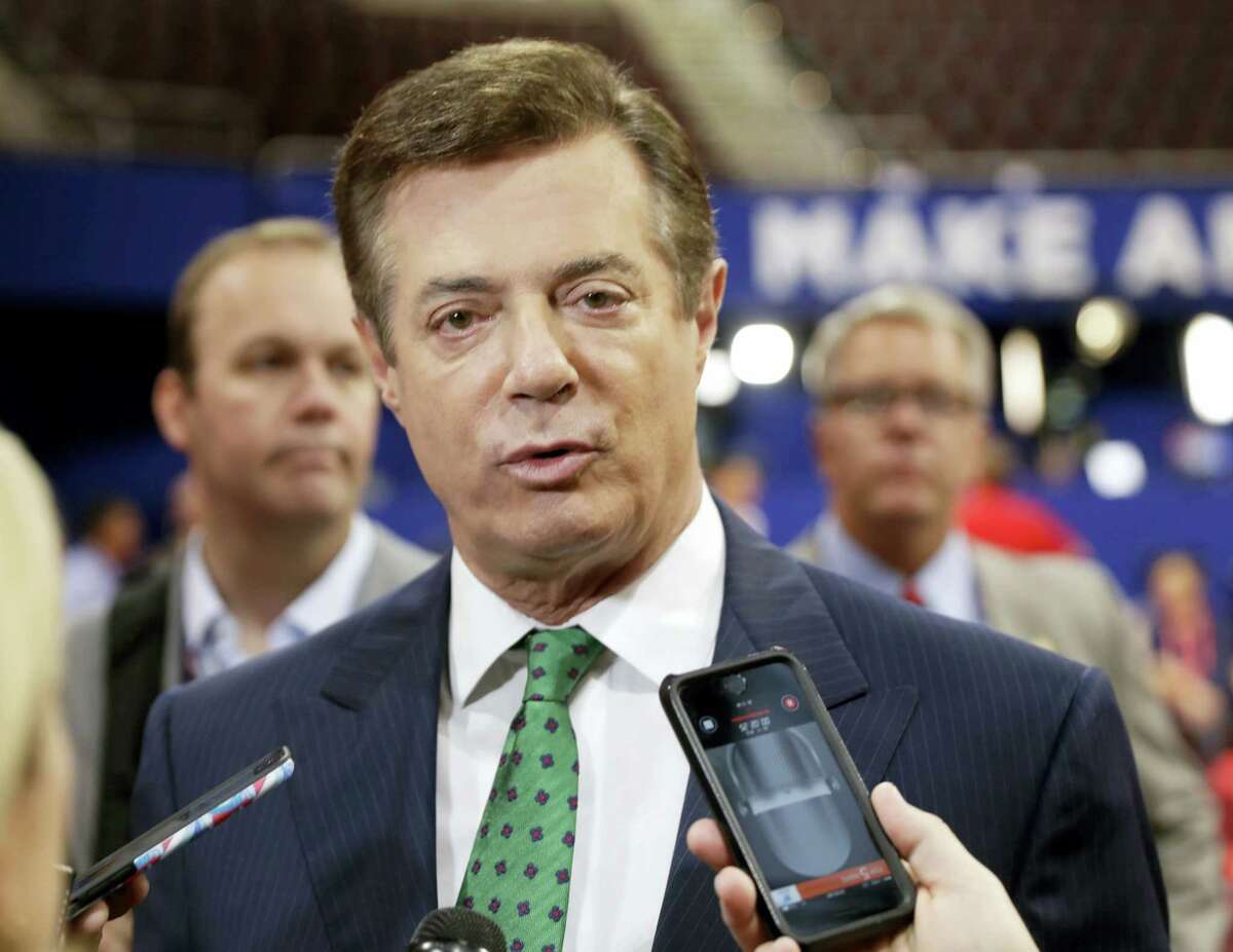 In this July 17, 2016 file photo, Trump campaign chairman Paul Manafort talks to reporters on the floor of the Republican National Convention at Quicken Loans Arena in Cleveland as Rick Gates listens at back left. President Donald Trump’s eldest son and his former campaign chairman are agreeing to discuss being privately interviewed by a Senate committee investigating Russia’s meddling in the 2016 election.