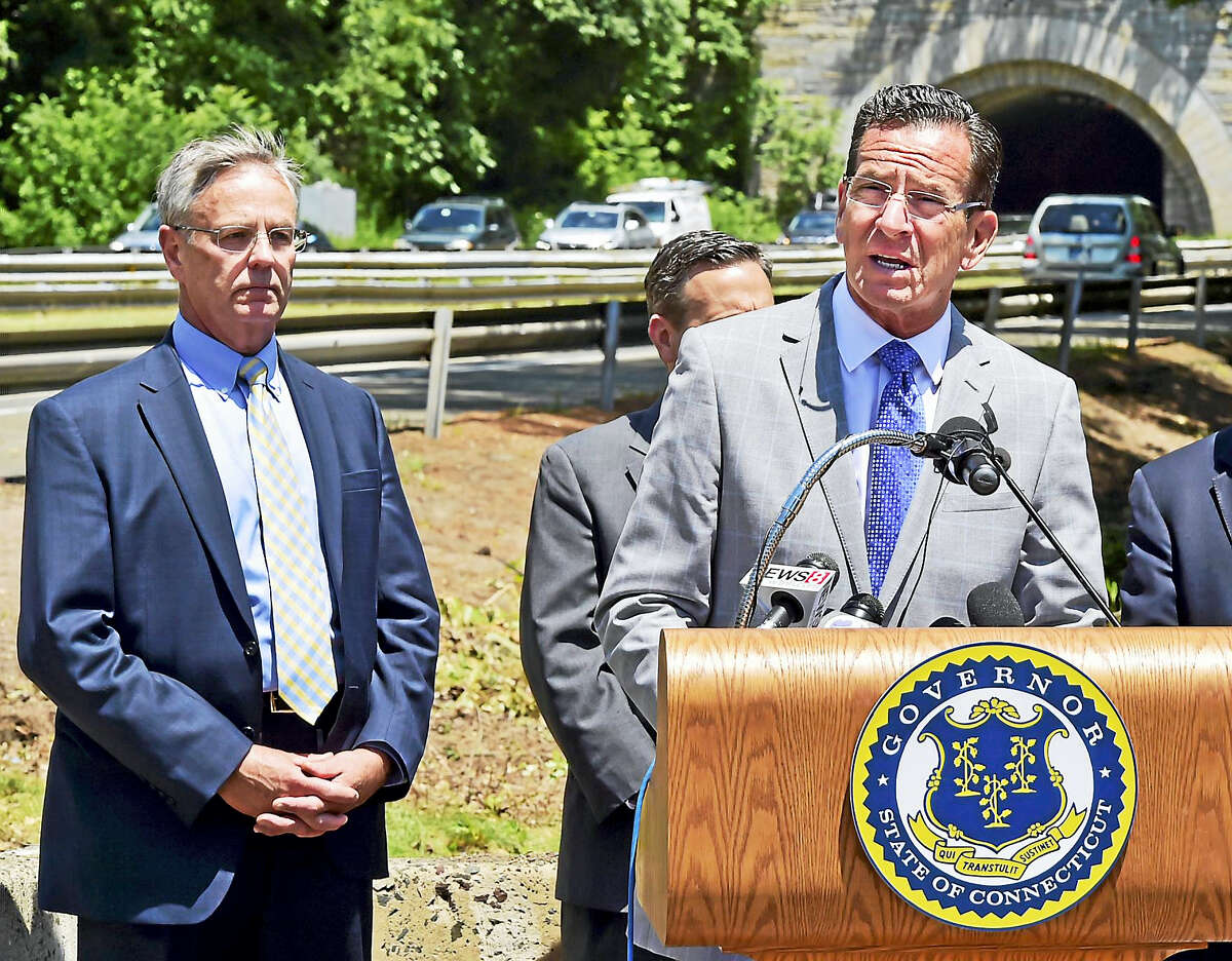 New Haven, Connecticut: July 5, 2017. Gov. Dannel P. Malloy during a press conference at the Department of Transportation District 3 Maintenance Facility on Pond Lilly Avenue in New Haven. At far left is Connecticut Department of Transportation Commissioner James P. Redeker.