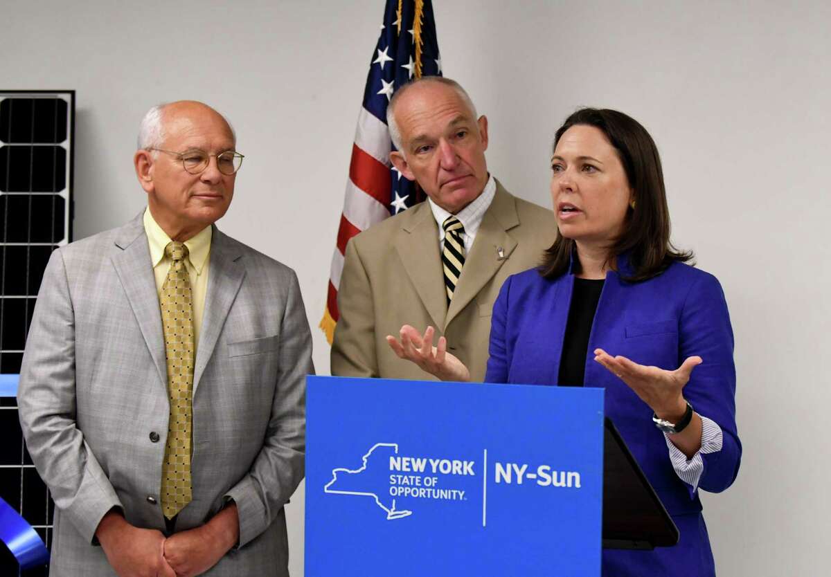 U.S. Rep. Paul Tonko, left, Scott Stevens, president of Dimension Fabricators, center, and Alicia Barton, president and CEO of NYSERDA speaks during a ribbon cutting event for a new solar array which was installed at Dimension Fabricators on Thursday, Aug. 3, 2017, in Glenville, N.Y. (Will Waldron/Times Union)