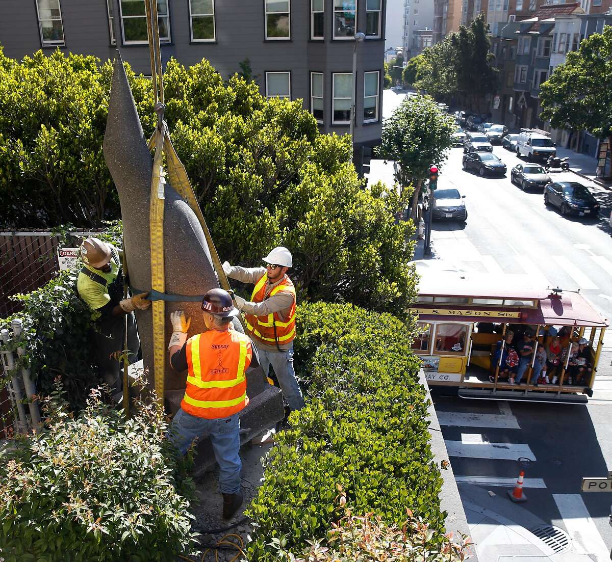 A penguin sculpture by Beniamino Bufano installed in the back corner of the Stanford Court Hotel is prepped for removal by a crane crew from its perch above Pine and Powell streets in San Francisco, Calif. on Saturday, July 22, 2017. The penguin will be restored and reinstalled in the main entrance to the hotel, which is undergoing a renovation, on California Street.