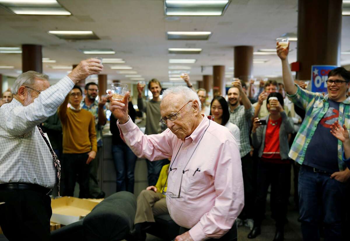 Veteran reporters Carl Nolte and David Perlman lead the newsroom at The San Francisco Chronicle in a toast as the paper celebrates 150 years of operation on Friday January 16, 2015 in San Francisco, Calif.
