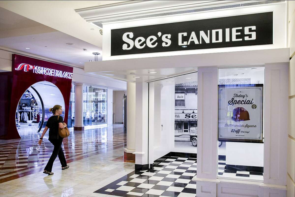 A woman walks past See's Candies inside the Stonestown Galleria on Tuesday, Aug. 1, 2017, in San Francisco, Calif.