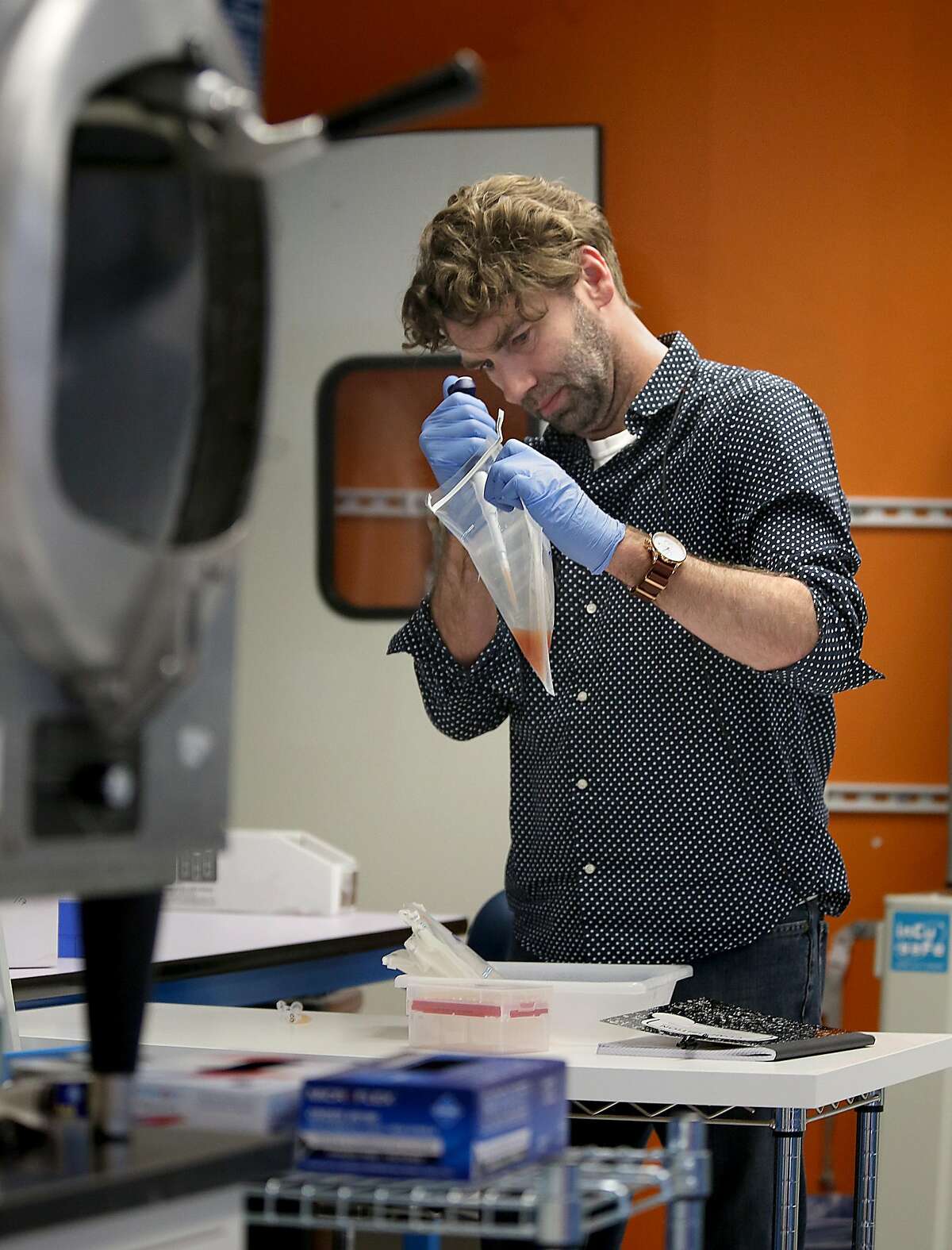 Senior scientist Chris Haney takes a sample of water rinsed from chicken skin to do an analysis at Clear Labs which conducts DNA sequencing and analysis of food samples on Thursday, July 27, 2017, in Menlo Park, Calif.