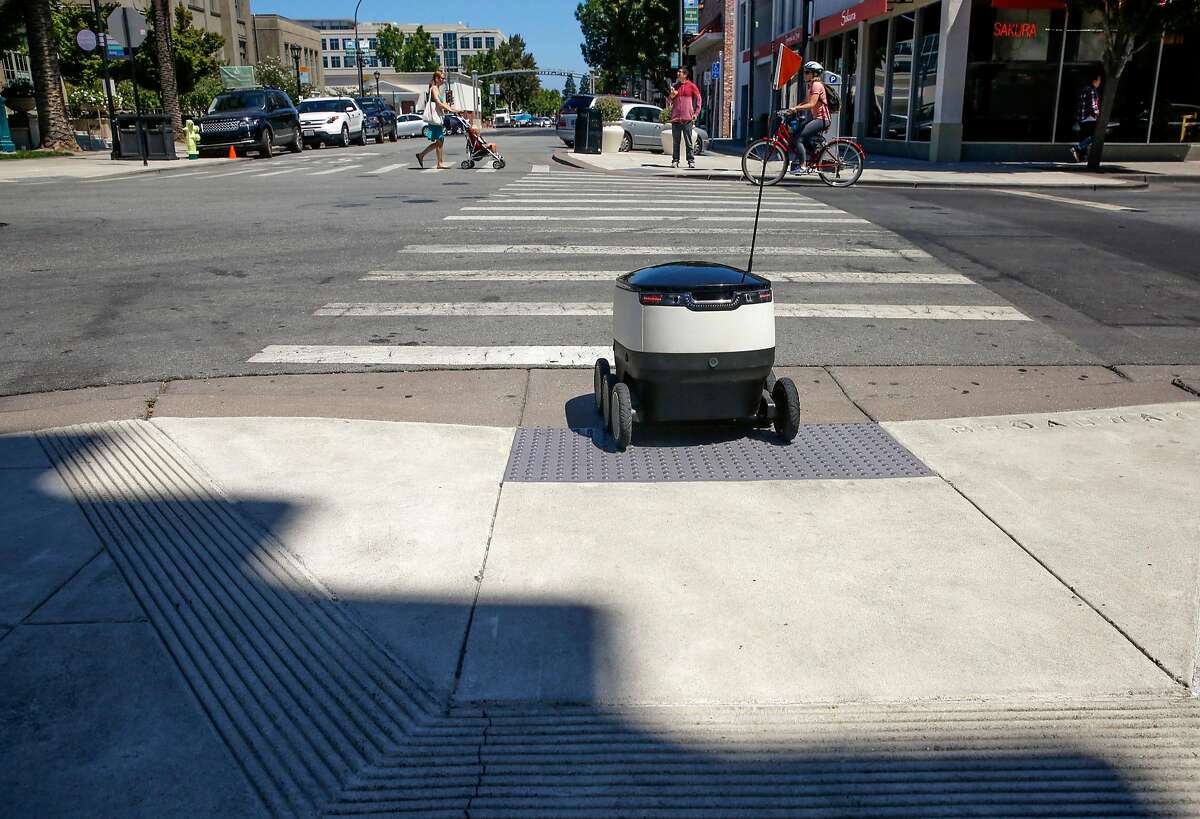 A Starship Technologies robot navigates streets in downtown Redwood City.