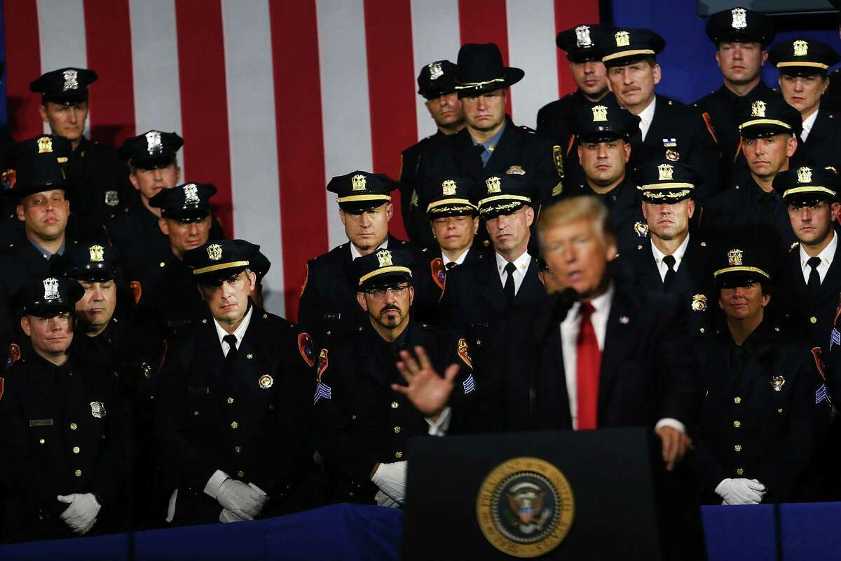 Police officers look on as President Donald Trump speaks at Suffolk Community College on July 28, 2017 in Brentwood, New York.