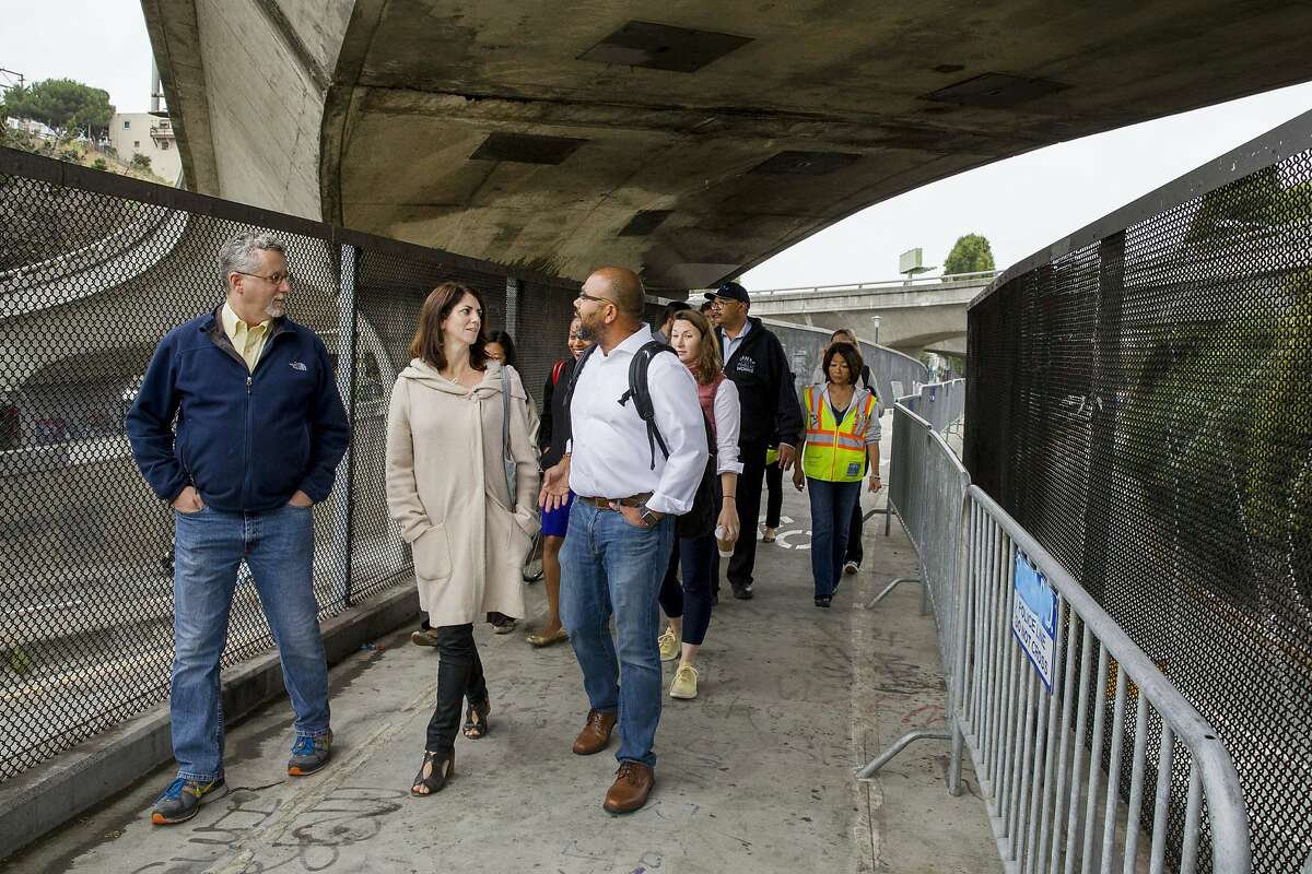 From left: Department of Homelessness and Supportive Housing director Jeff Kositsky, District 9 Supervisor Hillary Ronen and Department of Homelessness spokesperson Randy Quezada inspect the area near Cesar Chavez Street and Potrero Avenue on Wednesday, July 26, 2017, in San Francisco, Calif.