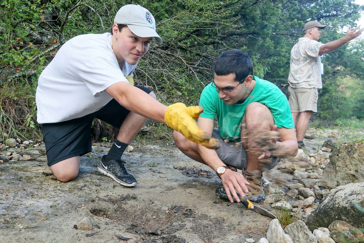 Callaway Metcalfe (left) and Richard Gonzalez clean debris from a theropod track. The tracks are found down the Joe Johnston Route.
