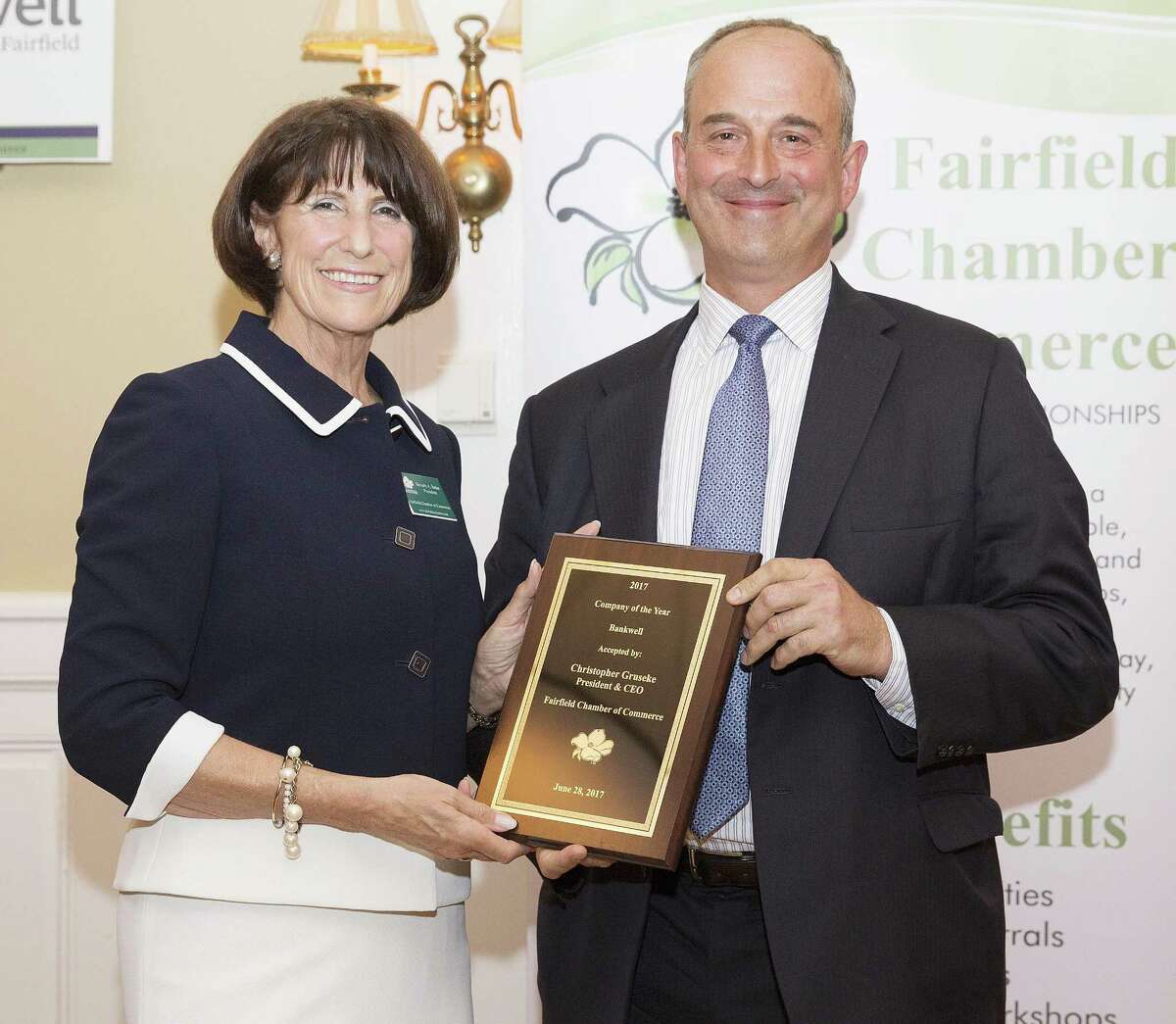 Fairfield Chamber of Commerce President Beverly Balaz, left, presents Bankwell President and CEO Christopher Gruseke with the chamber’s Company of the Year award.