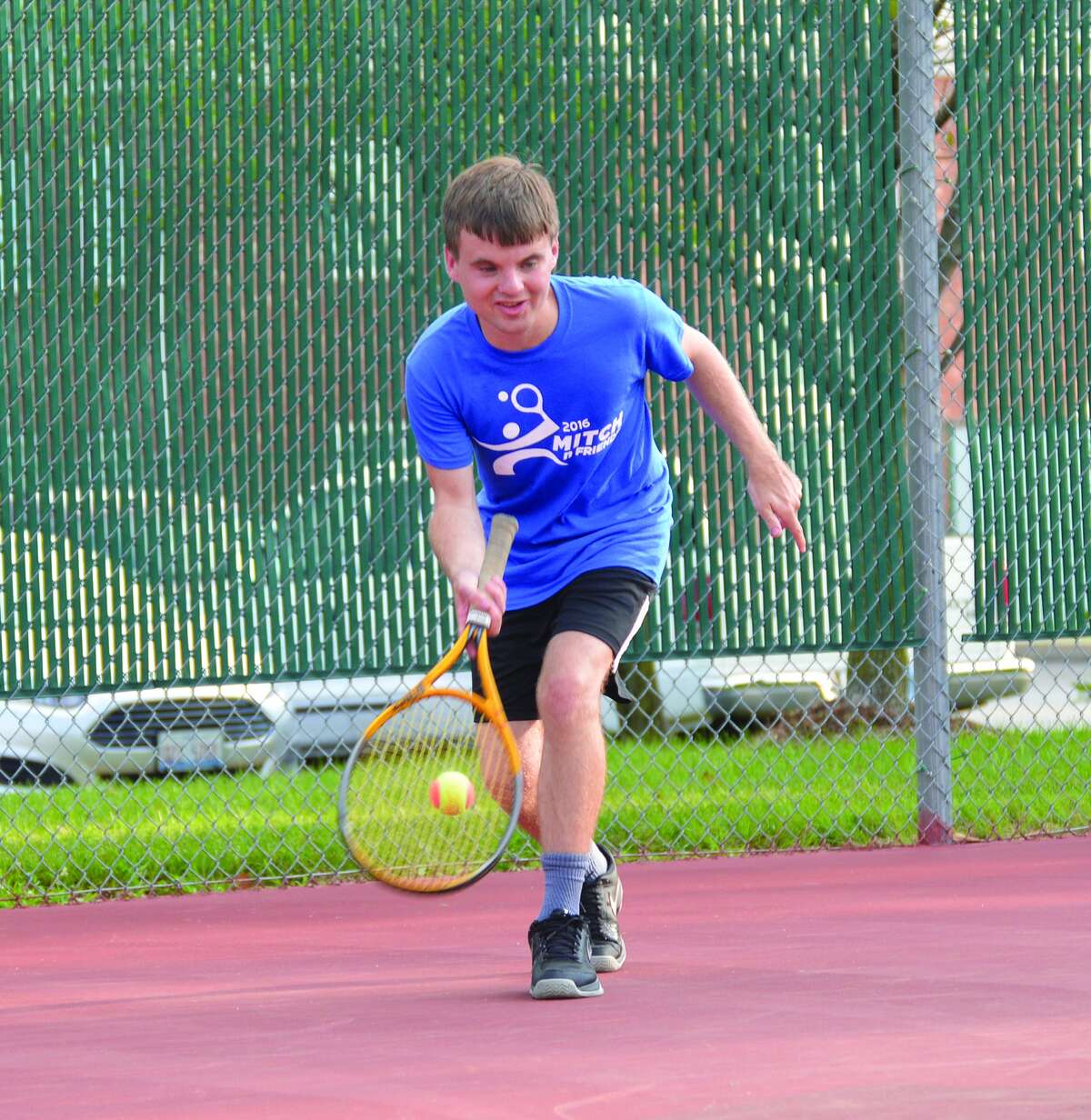 Mitch McGinnis returns a shot during the annual Mitch n’ Friends night at the Edwardsville High School Tennis Center.