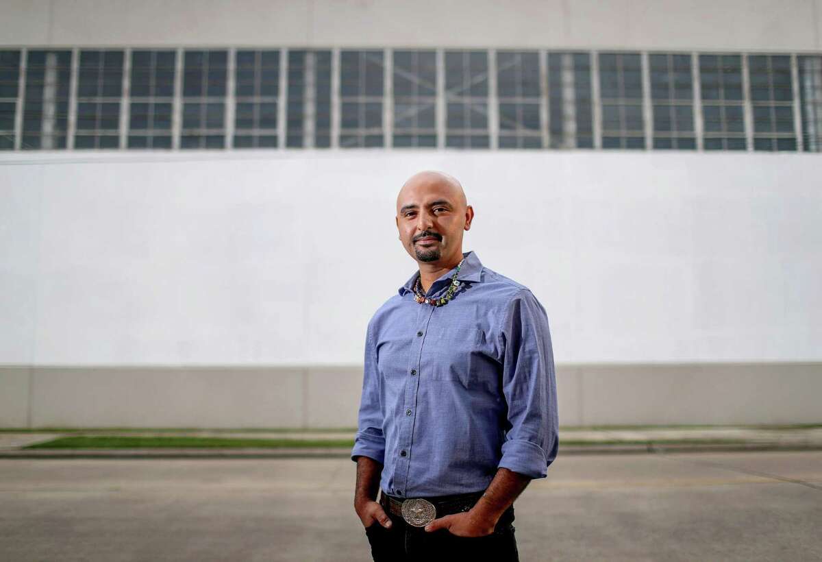 Houston artist Mario Figueroa, Jr., also known as "Gonzo247," poses for a portrait at the Harris County Records Building, at 5900 Canal St., Thursday, Aug. 3, 2017, in Houston. In 1973, artist Leo Tanguma painted a large mural titled, "The Rebirth of Our Nationality," on the exterior wall of the building. After years of deterioration, the original mural was whitewashed, and Figueroa was chosen to repaint the it.