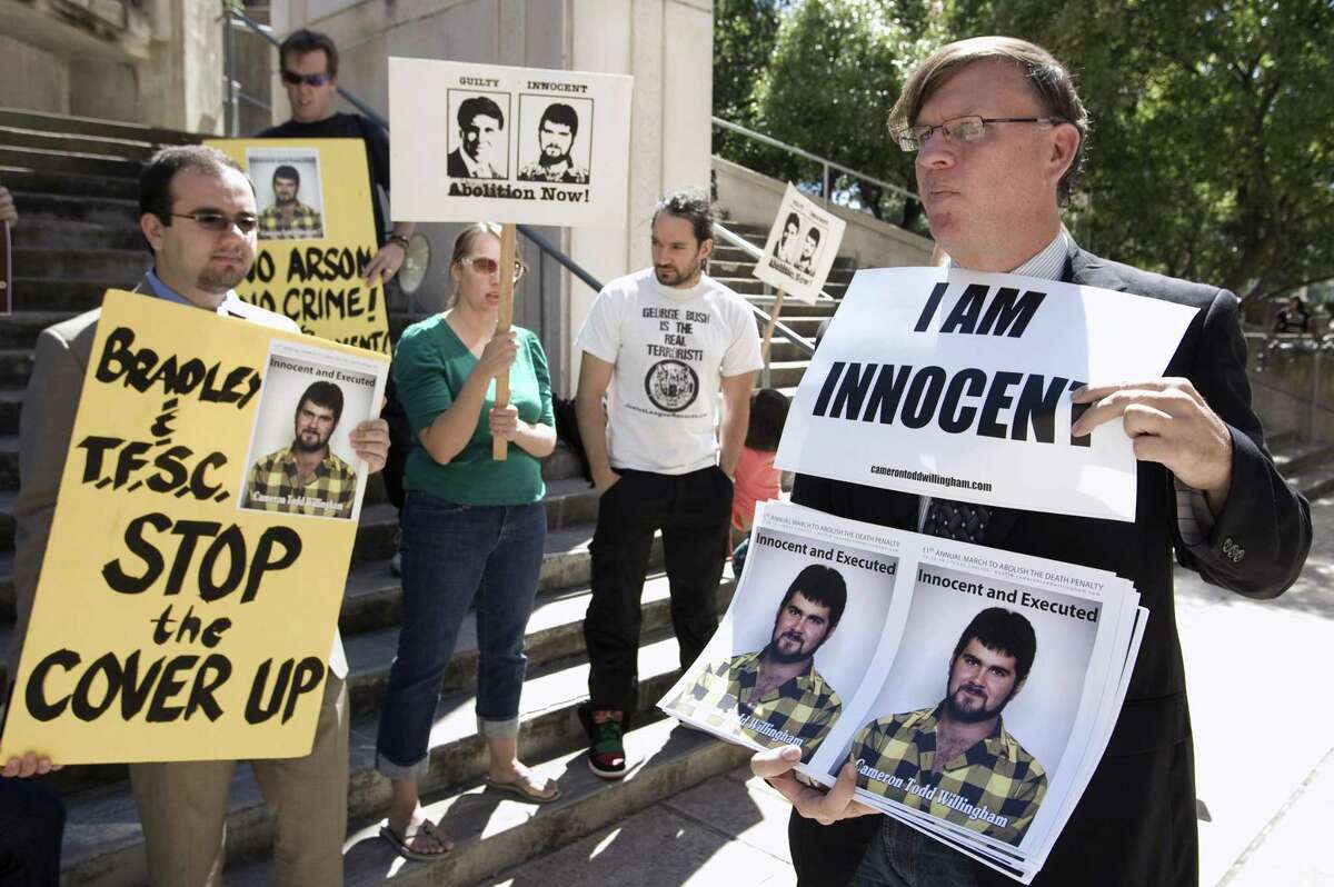 People protest before a hearing about the Cameron Todd Willingham case in Austin in 2010. It is likely that Willingham was wrongly convicted — and executed — because of junk science and a jailhouse informant who has since recanted.