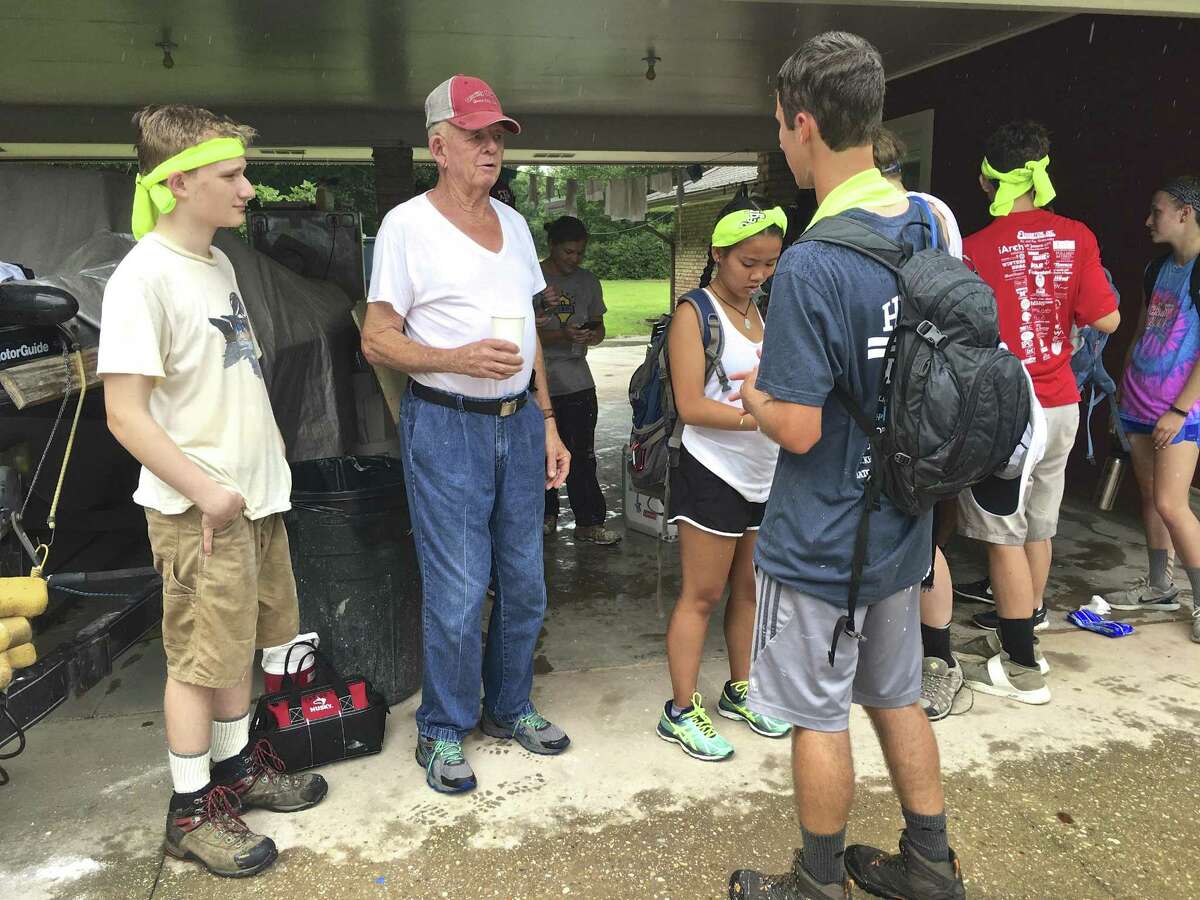 BLH youth volunteers listen to flood stories from Louis Harris of Denham Springs, LA
