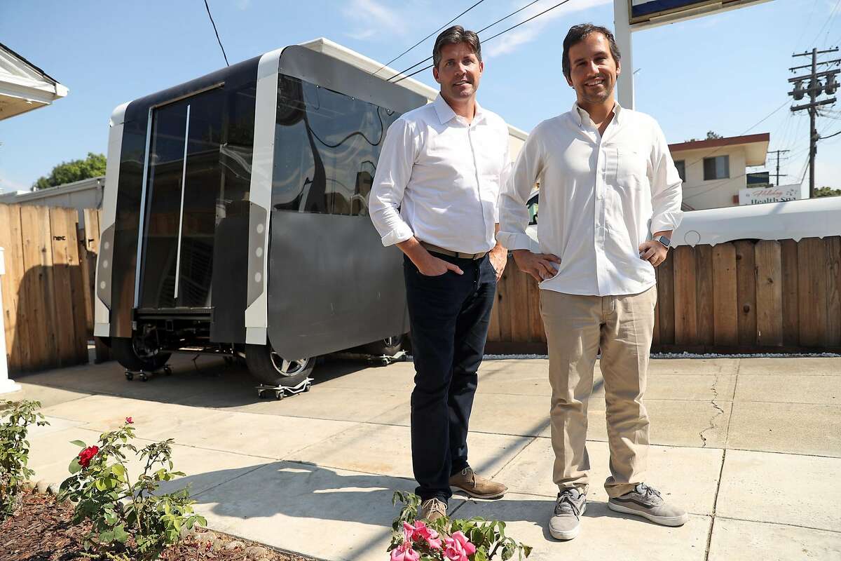 Next Future Transportation's Emmanuele Spera (right) and Sven Hackmann with Spera's self-driving transportation system pod prototype at the business in San Jose, Calif. on Wednesday, August 2, 2017.