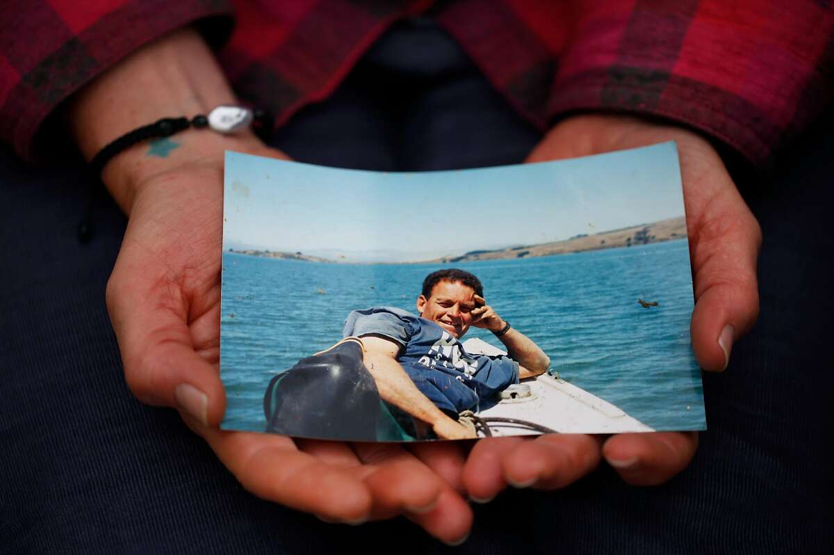 Heidi Gregory holds a photo of her father, Charles “Tod” Friend, owner of the Tomales Bay Oyster Co., who is believed to have drowned.