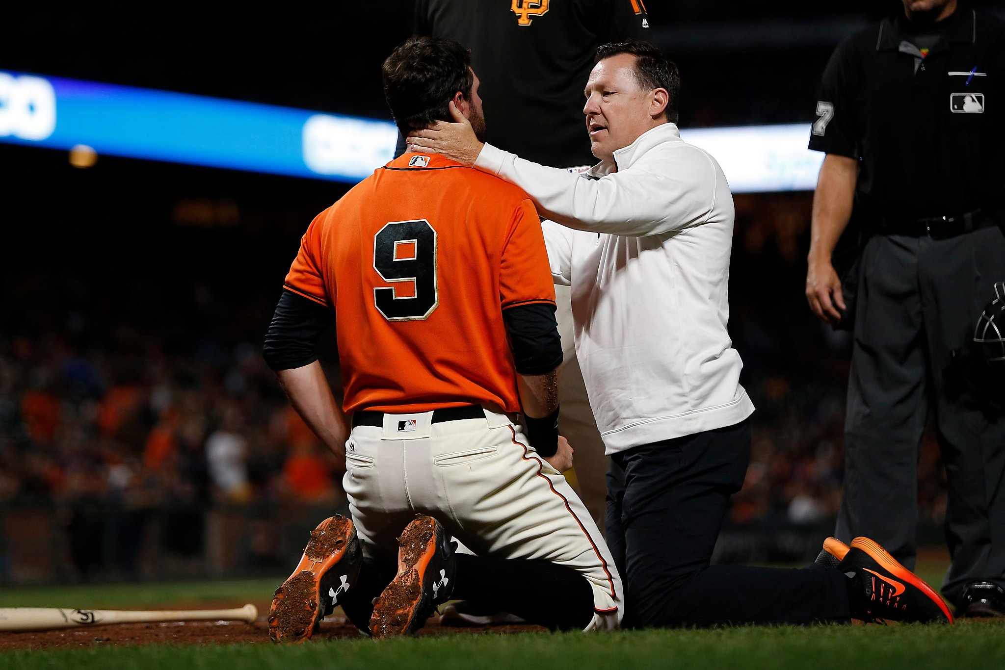 Giants' first baseman Brandon Belt falls over the rail and into