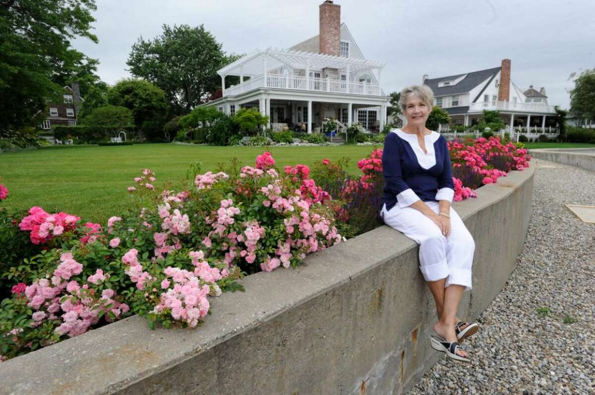 Chris Thurlow sits on a wall at her home on Shore Road, which was constructed after the 1992 storm, according to the laws of FEMA, on Wednesday, June 16, 2010.