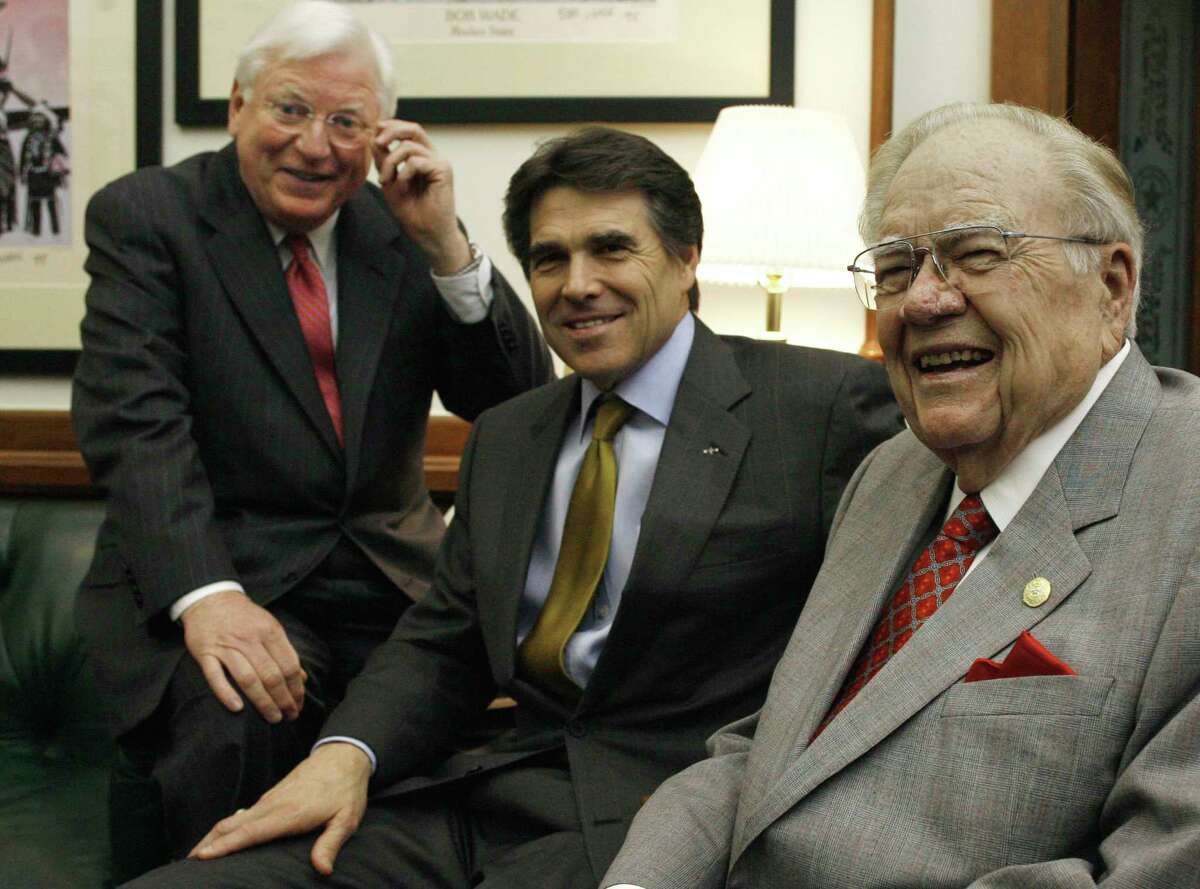 Former Texas governors Mark White, left, and Dolph Briscoe, right, visit with then-Gov. Rick Perry in his office in 2007. The two made the trip to endorse Perry's cure for cancer initiatives.