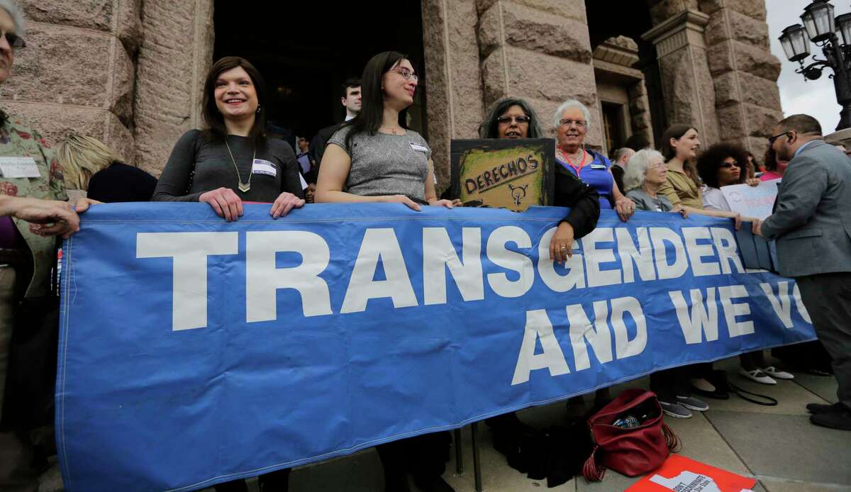 Members of the transgender community take part in a rally on the steps of the Texas Capitol, Monday, March 6, 2017, in Austin, Texas. The group is opposing a "bathroom bill" that would require people to use public bathrooms and restrooms that correspond with the sex on their birth certificate. (AP Photo/Eric Gay)