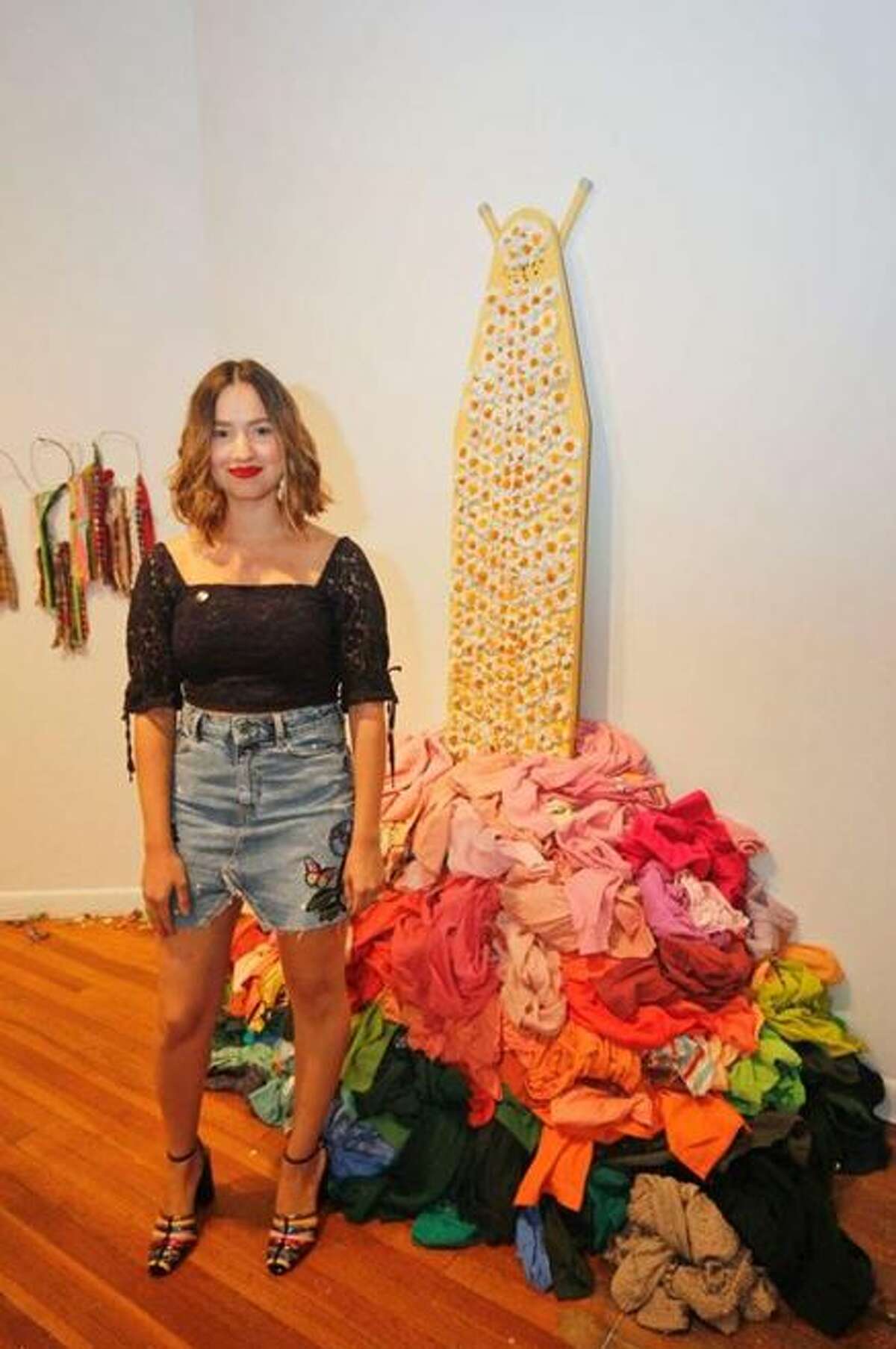 Daniela Cavazos Madrigal poses with her artwork featured in the Mexic-Arte Museum in Austin.  