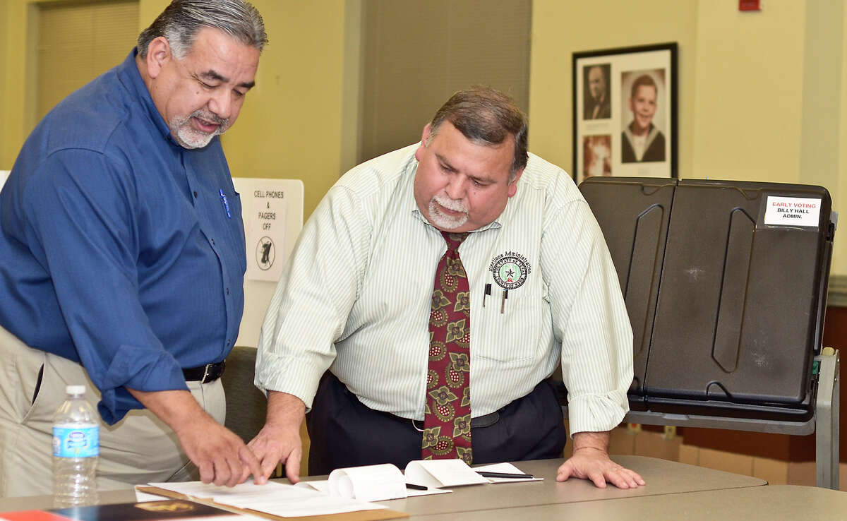 Armando X. Lopez and County Elections Coordinaor, Oscar Villareal, go over the results of the voting equipment tests, before preparing to mail them out, Tuesday afternoon at the Bill Hall Webb County Administration Building.