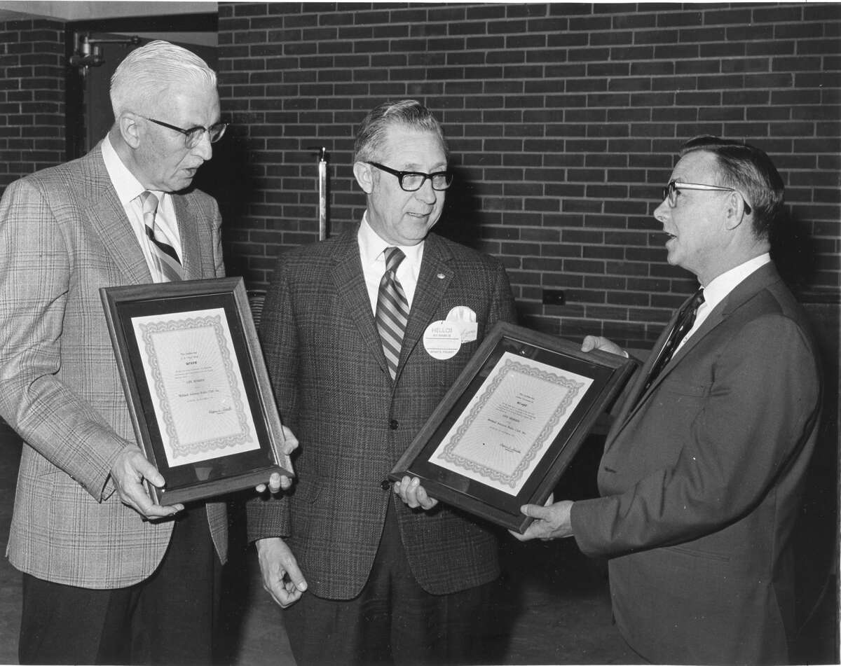 Two life memberships to the Midland Amateur Radio Club were presented to C.E. Bud Price, left, of Hemlock, and Arthur Townsend Jr., center, of Midland. David Russell, director of the community center, presented the awards. April 1970  