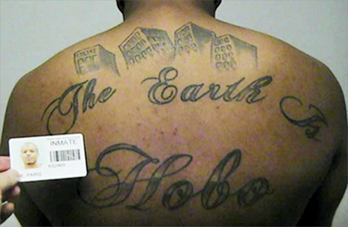FILE- This undated file photo provided by the United States Attorney's office in Chicago, shows Paris Poe's back tattoo that reads "The Earth Is Our Turf", and Hobo. Poe was one of six defendants that were on trial for racketeering and other charges. Body art has played a role in a surprising number of criminal cases nationwide, though legal experts concede that tattoos by themselves are rarely a deciding factor in convictions. (United States Attorney's office in Chicago via AP, File)
