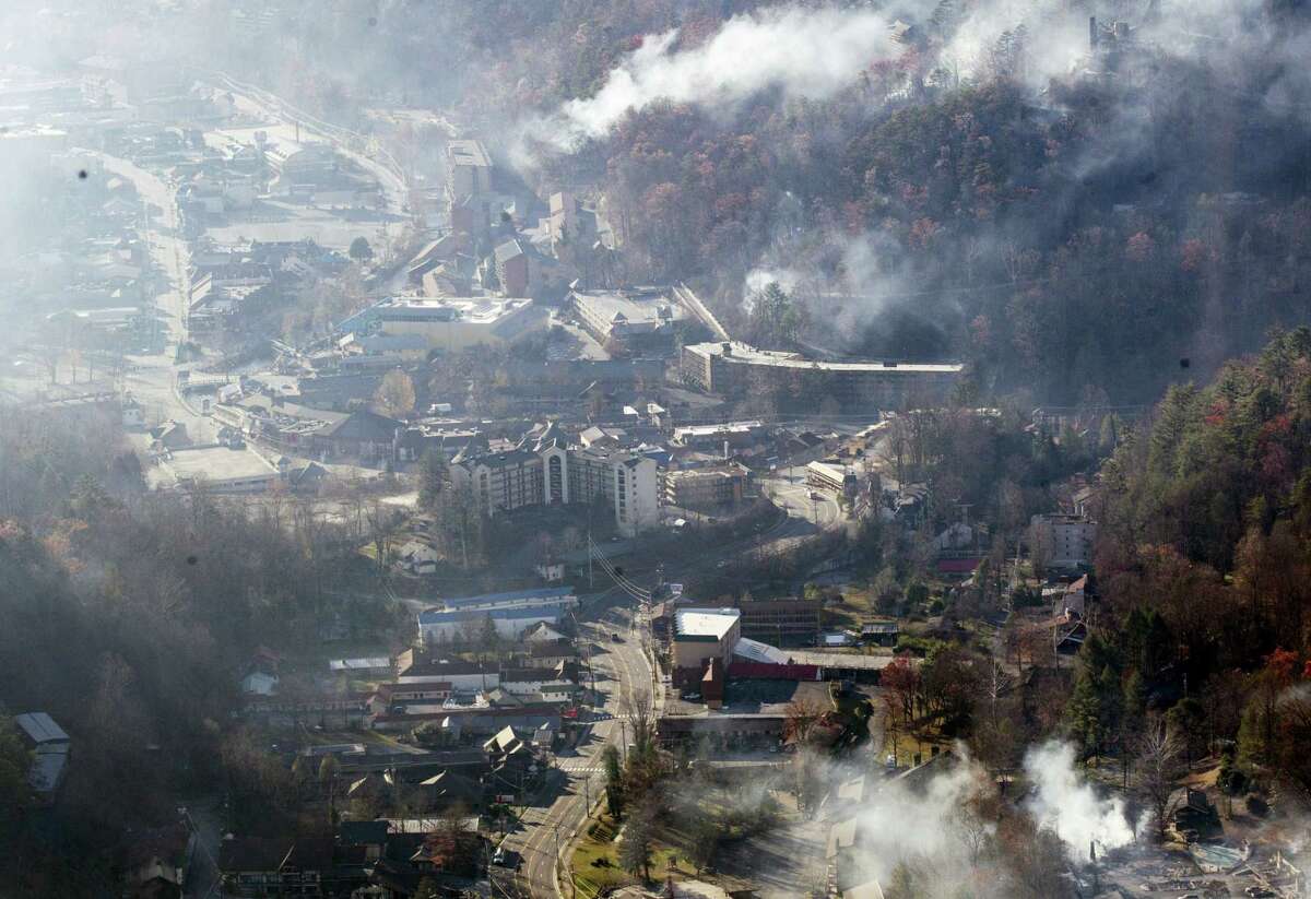 Burned structures are seen from aboard a National Guard helicopter near Gatlinburg, Tenn., Tuesday, Nov. 29, 2016. Thousands of people raced through a hell-like landscape to escape wildfires that killed several people and destroyed hundreds of homes in the Great Smoky Mountains. (AP Photo/Erik Schelzig)