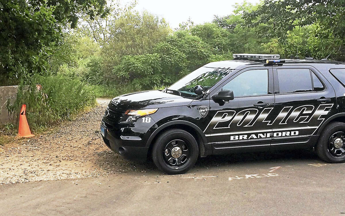 (Wes Duplantier/The New Haven Register)Branford police were investigating Wednesday after town workers discovered a man's body in a large town-owned property off of Tabor Drive. Police said the man had been there for nearly a day.