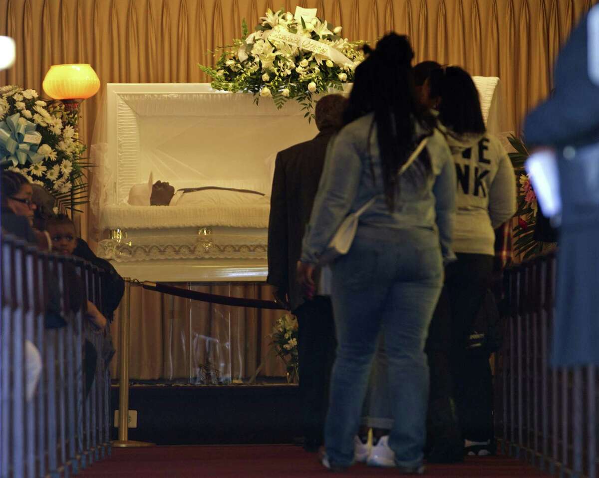 The body of Freddie Gray lies inside his casket at Vaughn Greene Funeral Home, during his wake Sunday, April 26, 2015 in Baltimore. Gray died from spinal injuries about a week after he was arrested and transported in a police van. (AP Photo/Jose Luis Magana)