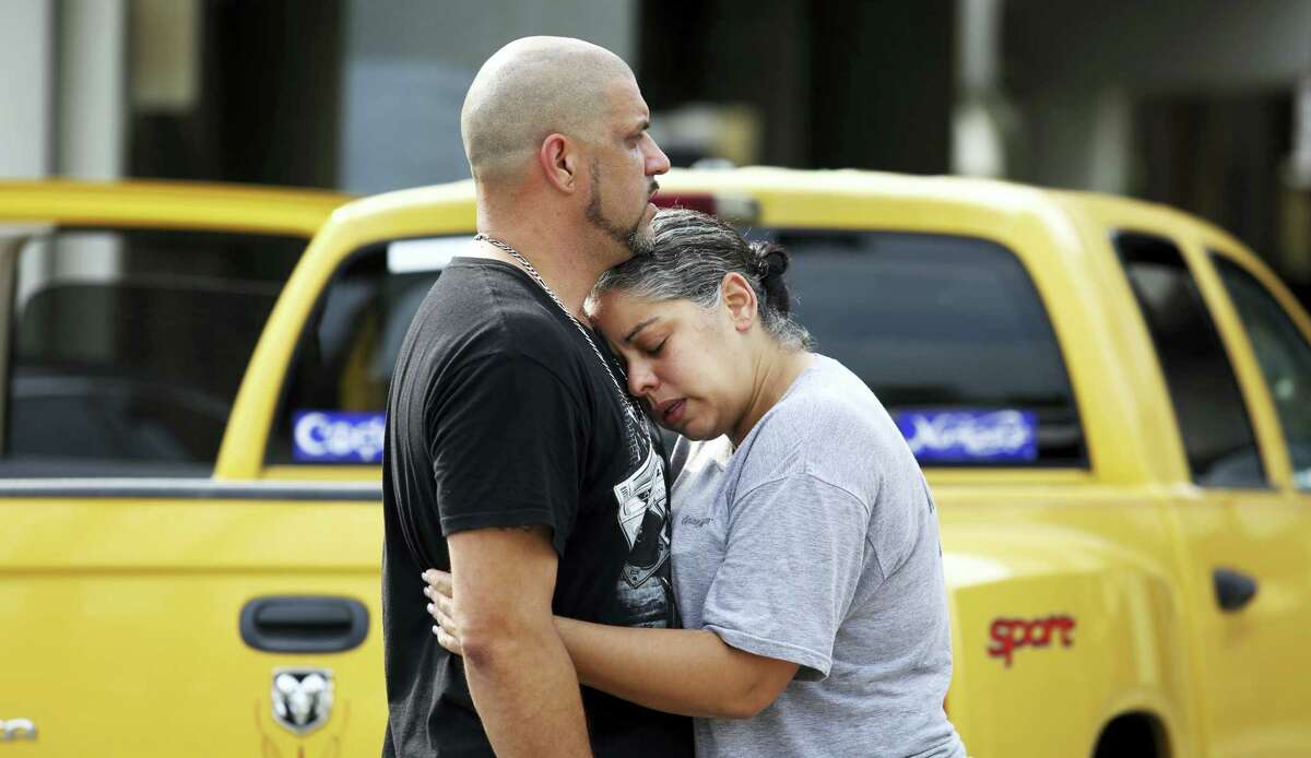 Ray Rivera, a DJ at Pulse Orlando nightclub, is consoled by a friend, outside of the Orlando Police Department after a shooting involving multiple fatalities at the nightclub, Sunday, June 12, 2016. (Joe Burbank/Orlando Sentinel via AP) MAGS OUT; NO SALES; MANDATORY CREDIT