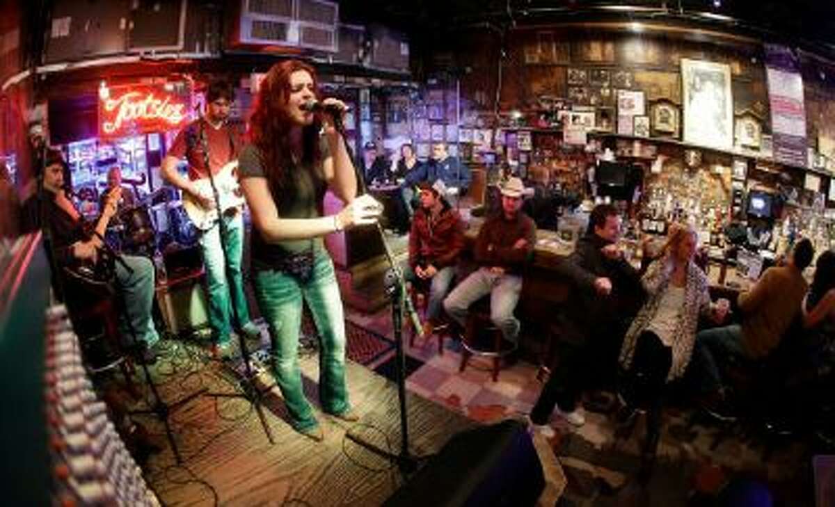 This Jan. 15, 2014 photo shows people listening to a band in Tootsie's Orchid Lounge in Nashville, Tenn. Tourists and locals flock to the row of honky tonks on lower Broadway.