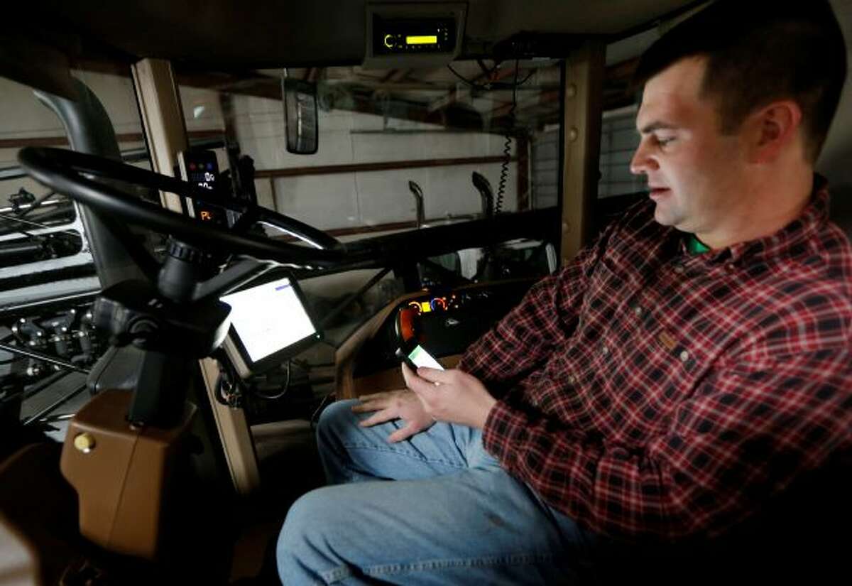 Nick Guetterman looks over the data shared by his crop sprayer and cell phone while on his farm near Bucyrus, Kan., Wednesday, Feb. 19, 2014. Farmers from across the nation gathered in Washington this month for their annual trek to seek action on the most important matters in American agriculture. But this time, a new issue emerged: growing unease about how the largest seed companies are gathering vast amount of data from sensors on tractors, combines and other farm equipment. The...