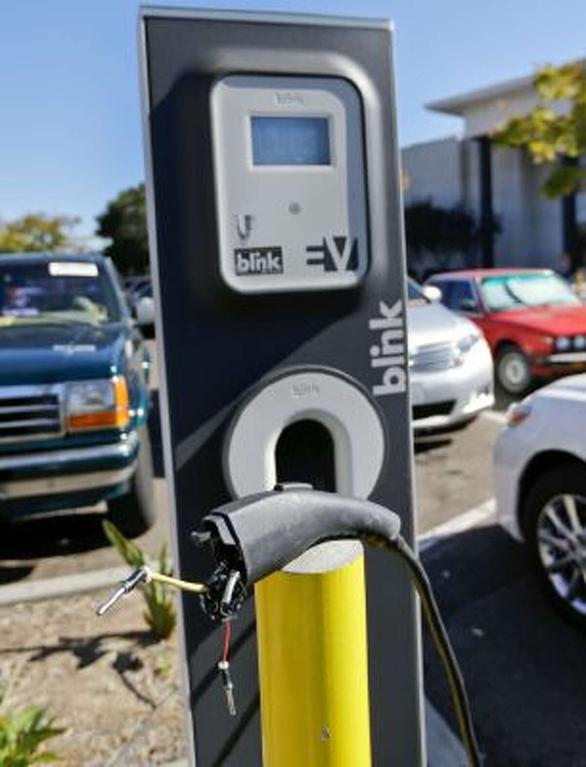 The cord at a electric vehicle charging station is damaged and unusable at a mall Nov. 13, 2013, in San Diego. The station had four charging units including one in a handicap parking area.