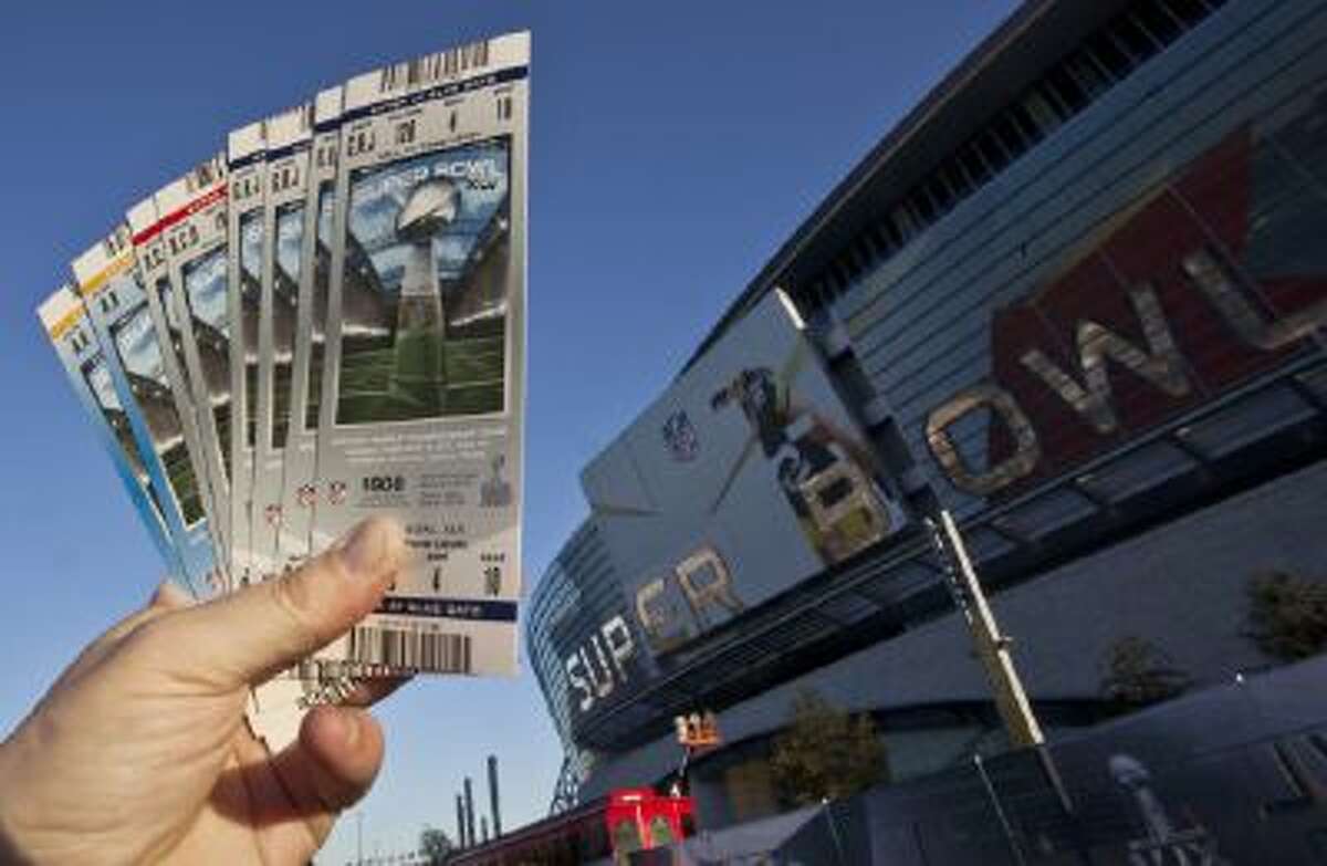In this Jan. 28, 2011, file photo, some NFL football Super Bowl XLV tickets are held outside Cowboys Stadium in Arlington, Texas.