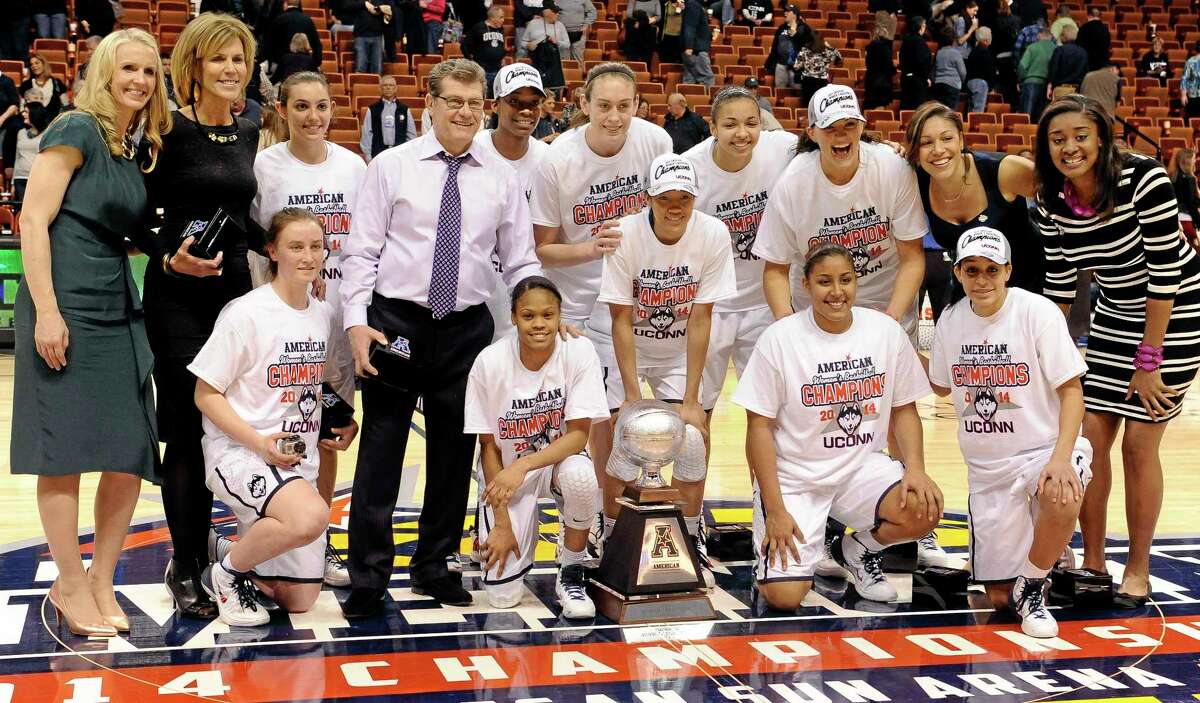 The Connecticut team poses for a photograph with their trophy after winning an NCAA college basketball game in the finals of the American Athletic Conference women's basketball tournament against Louisville, Monday, March 10, 2014, in Uncasville, Conn. Connecticut won 72-52. (AP Photo/Jessica Hill)