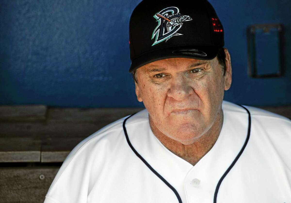 Pete Rose sits in the dugout at The Ballpark at Harbor Yard, Monday, June 16, 2014, in Bridgeport, Conn. Rose, banned from Major League Baseball, returned to the dugout for one day to manage the independent minor-league Bridgeport Bluefish. (AP Photo/Jessica Hill)
