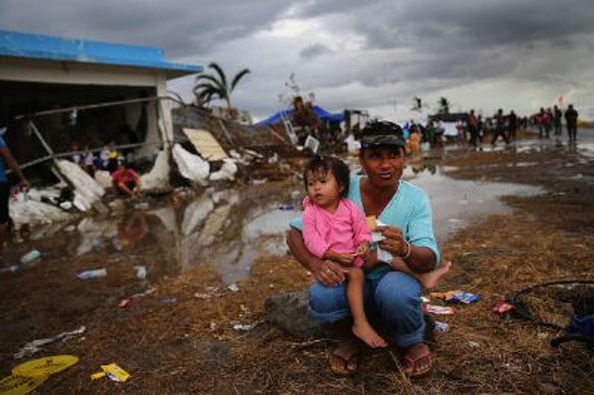 People wait to board a rescue flight in Tacloban Airport on November 14, 2013 in Leyte, Philippines.