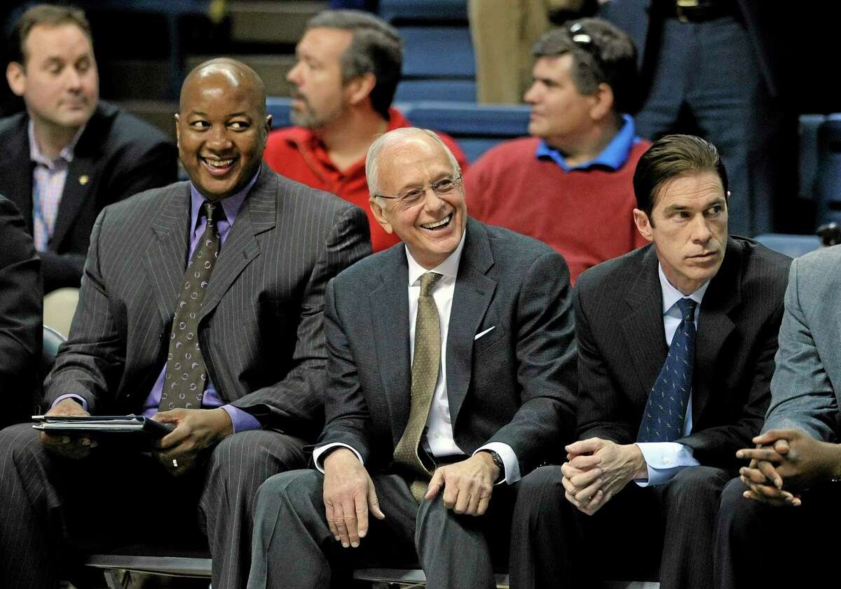 SMU head coach Larry Brown, center, enjoys a moment before his team’s 64-55 victory over Connecticut in Storrs on Sunday.