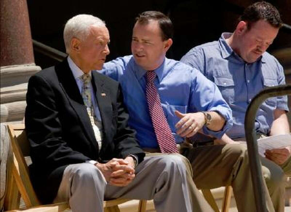 Utah Senators Orrin Hatch, left and Mike Lee talk before a rally for a balanced budget amendment at the Salt Lake City-County Building Friday July 8. State Representative Karl Wimmer at right.