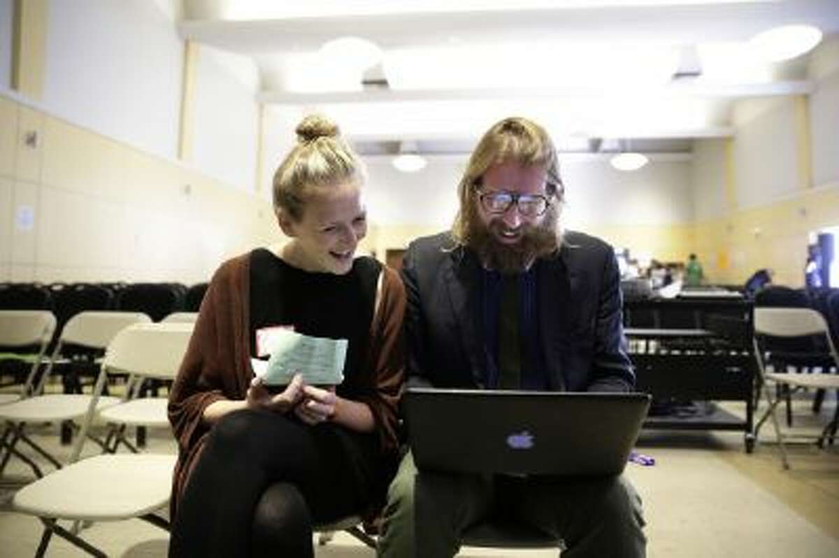 British comedians and co-founders of the Sunday Assembly, Sanderson Jones, right, and Pippa Evans smile as they go over their presentation before the Sunday Assembly on Sunday, Nov. 10, 2013, in Los Angeles.