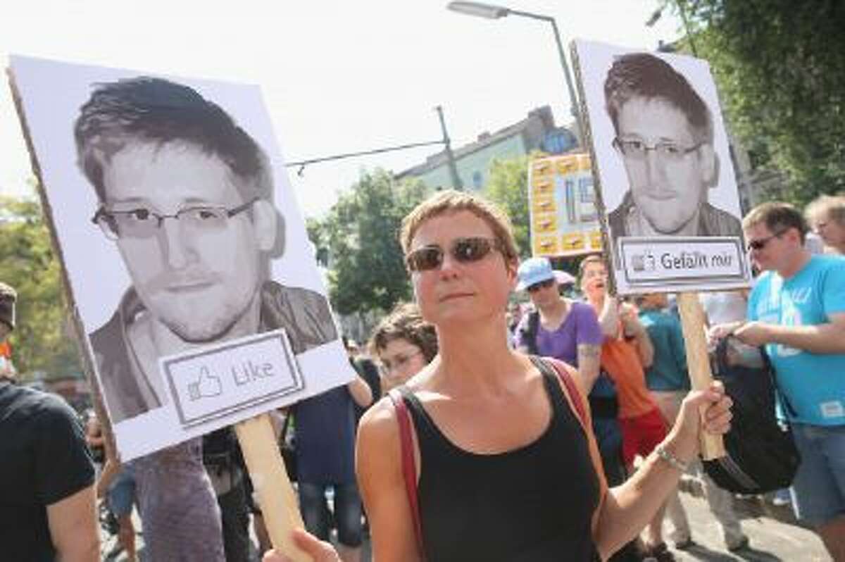A participant demonstrates in support of former NSA employee Edward Snowden at a protest march against the electonic surveillance tactics of the NSA on July 27, 2013 in Berlin, Germany.