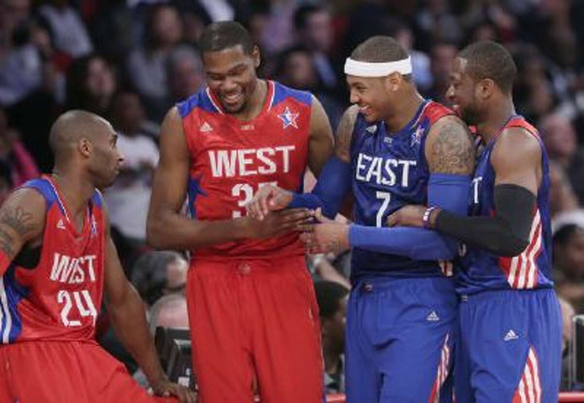 From left, West Team's Kobe Bryant, Kevin Durant, East Team's Carmelo Anthony and Dwyane Wade laugh during the first half of the NBA All-Star basketball game Sunday, Feb. 17, 2013, in Houston.