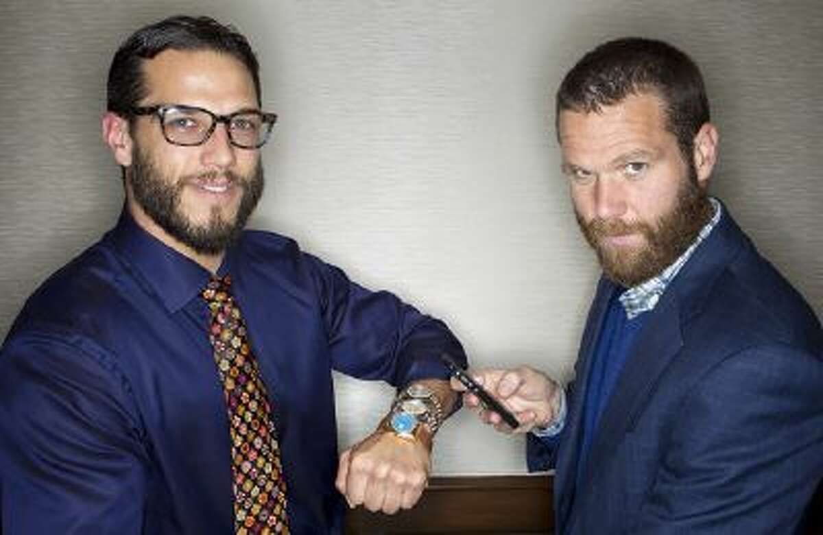 From left, Josh and Kris Bonifas pose with vintage Rolex watches and an iPhone at FourtanÈ in Carmel-by-the-Sea, Calif., on Friday, July, 19, 2013.