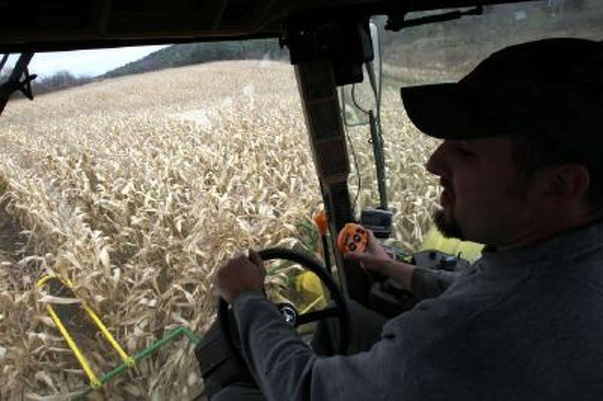 In this Oct. 21, 2013 photo, Tony Pouliot harvests a corn field in Westford, Vt. Farmers can now use smart phones and computers to monitor and modify what nutrients they add to their soil, thanks to a new computer app created by a University of Vermont researcher.