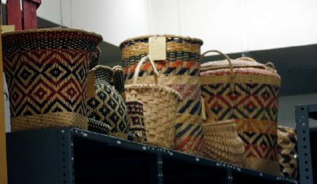 In this Oct. 11, 2013 photograph, Mississippi tribes of Native American-made baskets line the tops of shelves in storage and will be among the items that will eventually be displayed in one of two museums planned for Jackson, Miss.