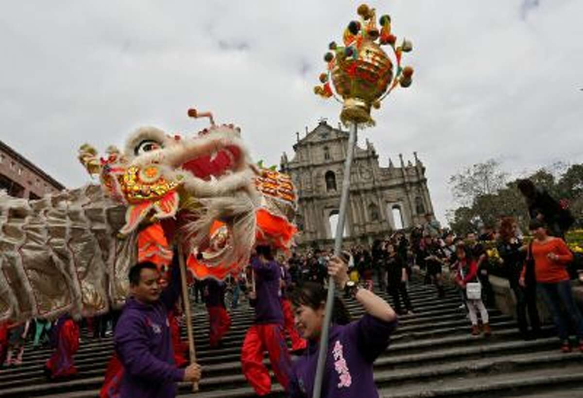 In this Feb. 1, 2014 photo, local artists perform dragon at the famous tourist spot the Ruins of St. Paul's during a Chinese New Year celebration in Macau.
