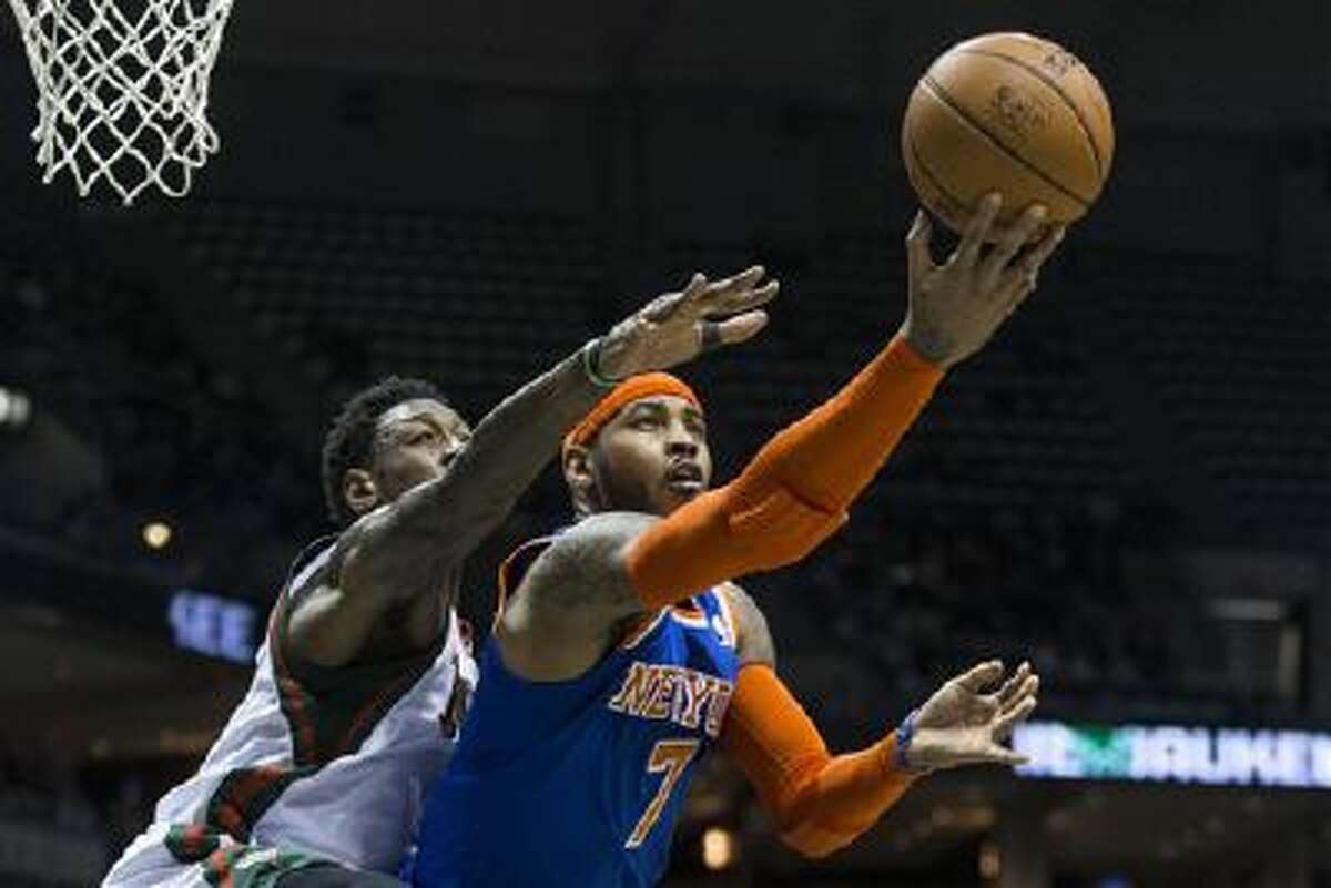 New York Knicks' Carmelo Anthony shoots the ball against Milwaukee Bucks' Larry Sanders during the first half of an NBA basketball game, Monday, Feb. 3, 2014, in Milwaukee. (AP Photo/Tom Lynn)