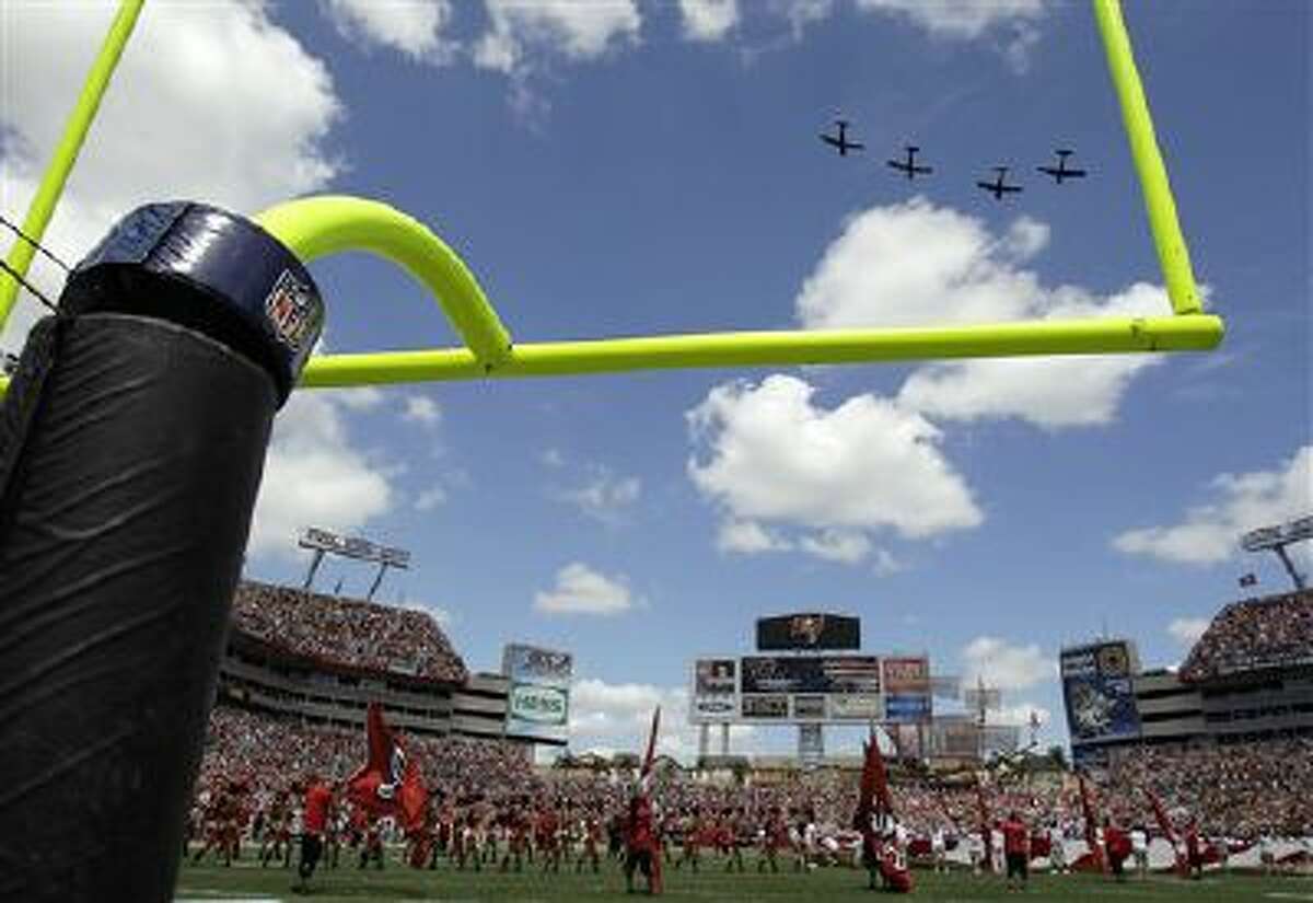 A military plane flyover the stadium between the Tampa Bay Buccaneers and the Pittsburgh Steelers during an NFL football game Sept. 26.