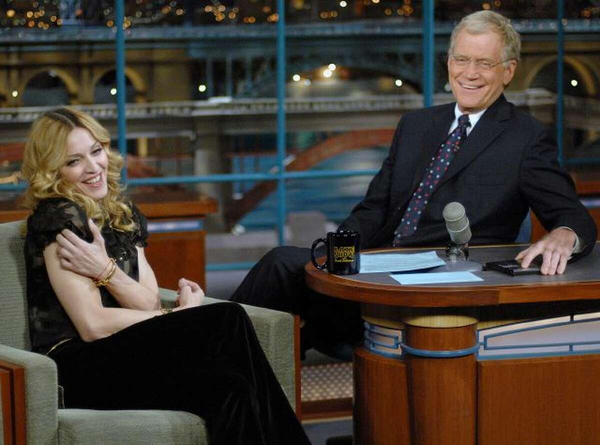 FILE - In this Jan. 11, 2006 file photo released by CBS, Madonna joins host David Letterman on the set of "The Late Show with David Letterman," in New York. Madonna was in town to attend a special screening of "Arthur and The Invisibles." Letterman announced his retirement during a taping on Thursday, April 3, 2014. Although no specific date was announced he told the audience that he will leave his desk sometime in 2015. (AP Photo/CBS, J P Filo, File) MANDATORY CREDIT; NO SALES; NO...