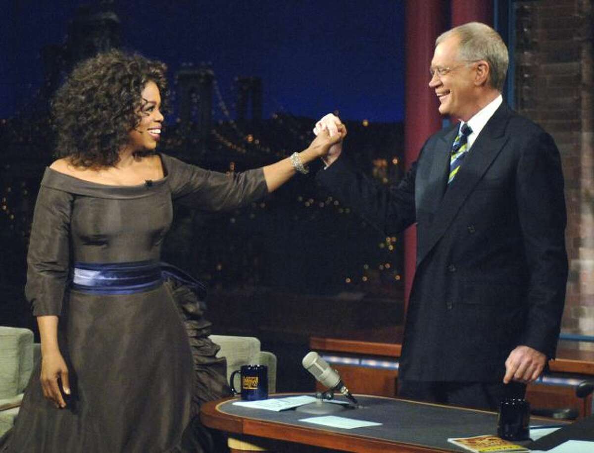 FILE - In this Dec. 1, 2005 file photo provided by CBS, Oprah Winfrey appears with David Letterman during a taping of on "The Late Show with David Letterman", in New York. Following the interview, Dave escorted Oprah across 53rd street to the opening of her new Broadway Show "The Color Purple". Letterman announced his retirement during a taping on Thursday, April 3, 2014. Although no specific date was announced he told the audience that he will leave his desk sometime in 2015. (AP...